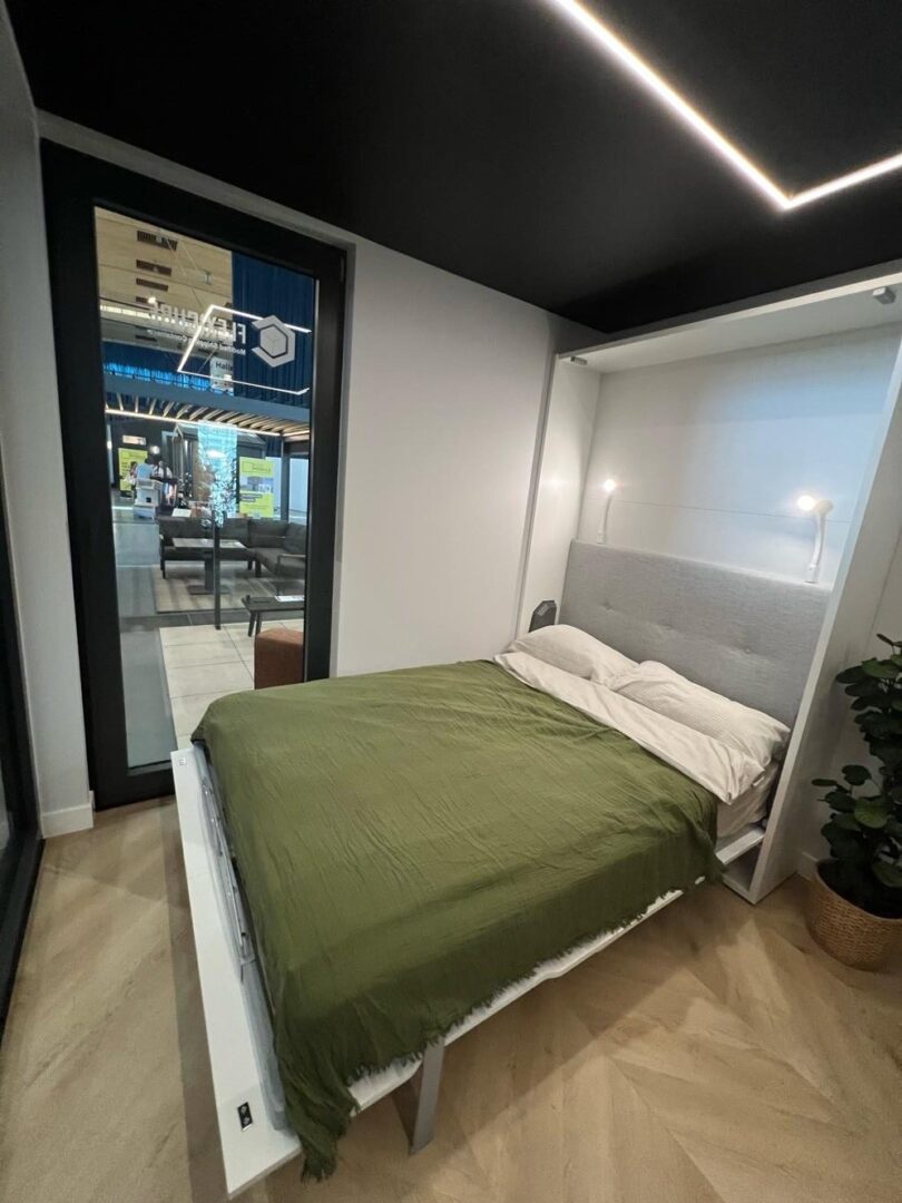 SmartBed folded out as a bed in the L15 XL Showroom container home